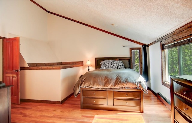 350 Old Fish Creek Falls Rd Unit 350, Steamboat Springs, CO 80487 - bedroom with lofted ceiling, a baseboard radiator, ornamental molding, light wood-style flooring, and a textured ceiling