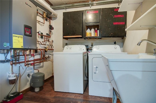 350 Old Fish Creek Falls Rd Unit 350, Steamboat Springs, CO 80487 - laundry room with washing machine and dryer, dark wood-style floors, water heater, and cabinet space