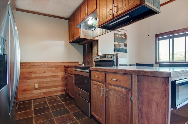 350 Old Fish Creek Falls Rd Unit 350, Steamboat Springs, CO 80487 - kitchen featuring stainless steel appliances, brown cabinetry, a peninsula, under cabinet range hood, and ornamental molding