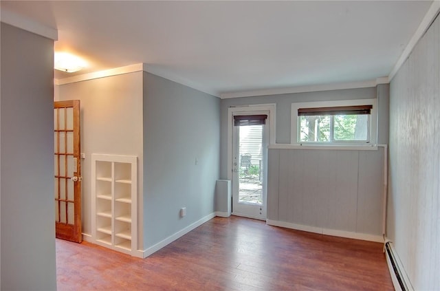 350 Old Fish Creek Falls Rd Unit 350, Steamboat Springs, CO 80487 - empty room with a baseboard radiator, wood finished floors, baseboards, and crown molding