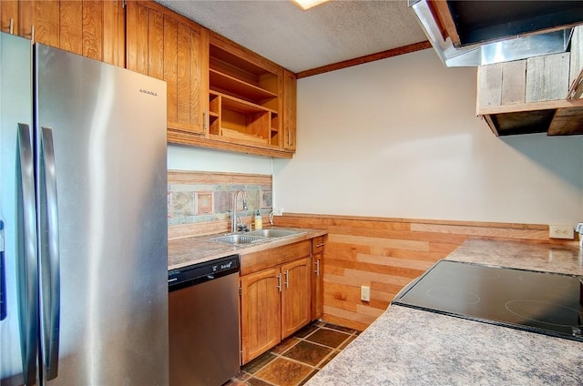 350 Old Fish Creek Falls Rd Unit 350, Steamboat Springs, CO 80487 - kitchen with stainless steel appliances, a sink, open shelves, wooden walls, and a wainscoted wall