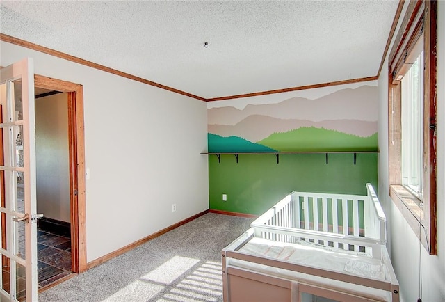 350 Old Fish Creek Falls Rd Unit 350, Steamboat Springs, CO 80487 - unfurnished bedroom with baseboards, carpet, a textured ceiling, and ornamental molding