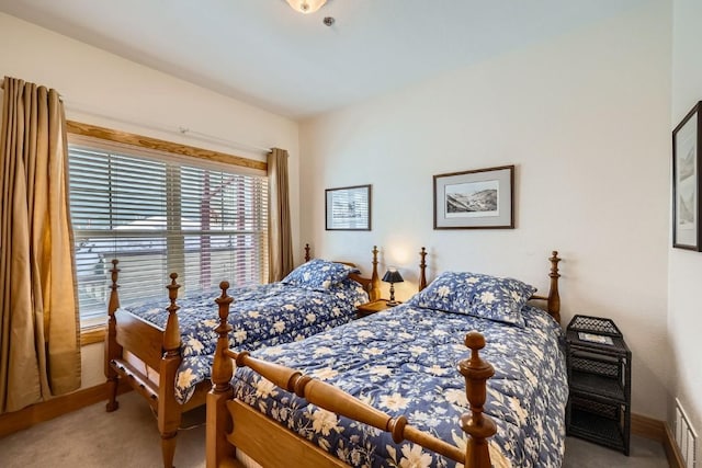 carpeted bedroom with baseboards and visible vents