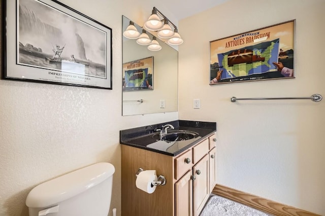 bathroom with toilet and vanity