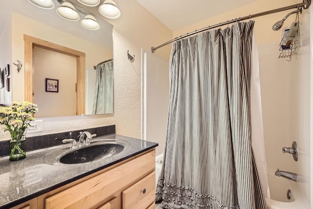 bathroom with shower / bath combo with shower curtain and vanity