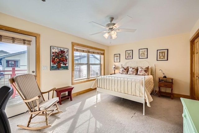 bedroom with ceiling fan, carpet flooring, baseboards, and multiple windows