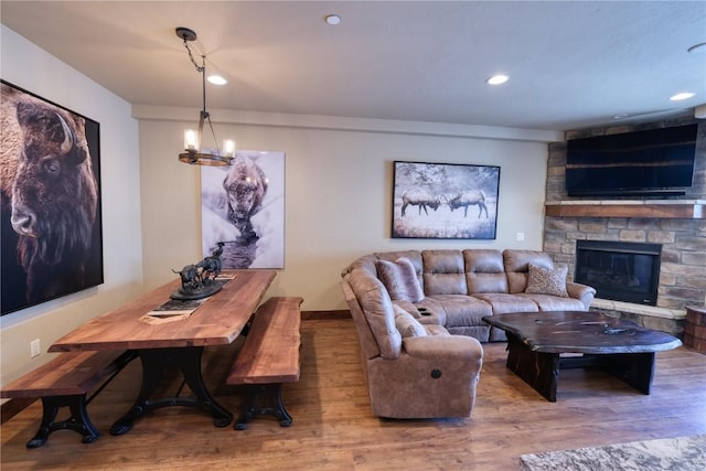 421 Rainbow Dr Unit 12, Silverthorne, CO 80498 - living room with wood finished floors, a stone fireplace, a chandelier, and recessed lighting