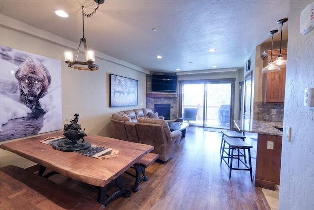421 Rainbow Dr Unit 12, Silverthorne, CO 80498 - dining space featuring hardwood / wood-style floors, a stone fireplace, and recessed lighting