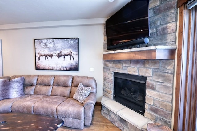 421 Rainbow Dr Unit 12, Silverthorne, CO 80498 - living room featuring wood finished floors and a stone fireplace
