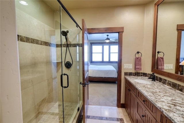 421 Rainbow Dr Unit 12, Silverthorne, CO 80498 - ensuite bathroom with vanity, ceiling fan, tile patterned floors, and a shower stall
