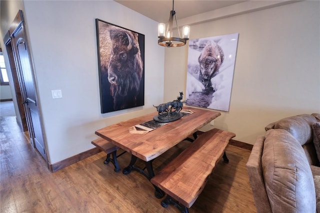 421 Rainbow Dr Unit 12, Silverthorne, CO 80498 - dining space with wood finished floors, a chandelier, and baseboards