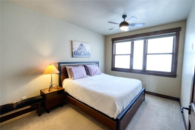 421 Rainbow Dr Unit 12, Silverthorne, CO 80498 - bedroom with light carpet, ceiling fan, and baseboards