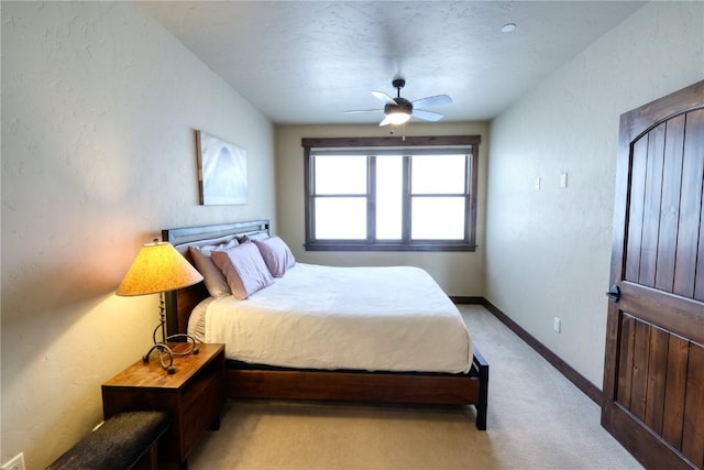421 Rainbow Dr Unit 12, Silverthorne, CO 80498 - bedroom with light carpet, baseboards, a ceiling fan, and a textured wall
