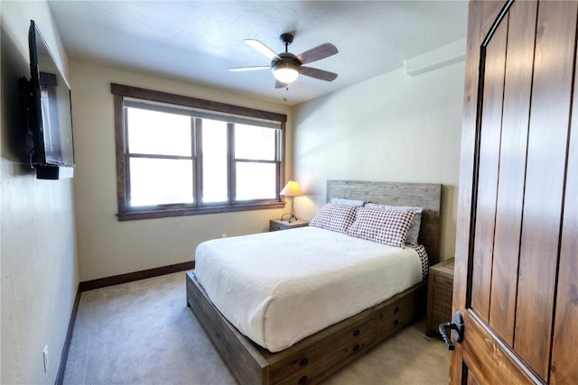421 Rainbow Dr Unit 12, Silverthorne, CO 80498 - bedroom with light carpet, baseboards, and a ceiling fan