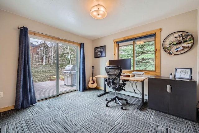 carpeted office space with plenty of natural light and baseboards
