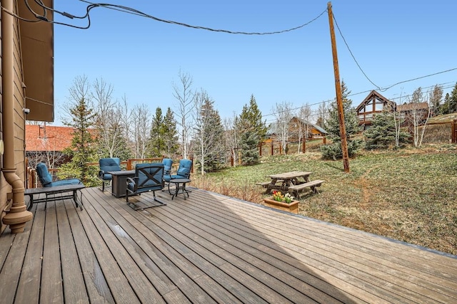 wooden terrace featuring a fenced backyard and a yard