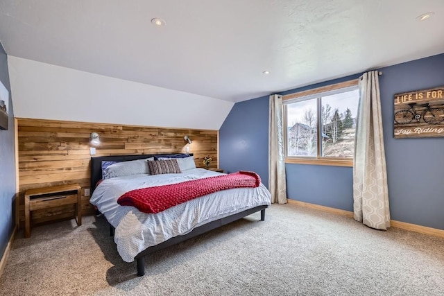 bedroom featuring wood walls, lofted ceiling, baseboards, recessed lighting, and carpet