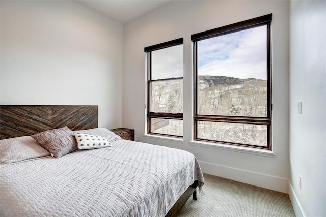 carpeted bedroom featuring multiple windows