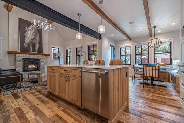 208 N Ridge St, Breckenridge, CO 80424 - kitchen with stainless steel dishwasher, hardwood / wood-style flooring, open floor plan, an inviting chandelier, and a fireplace