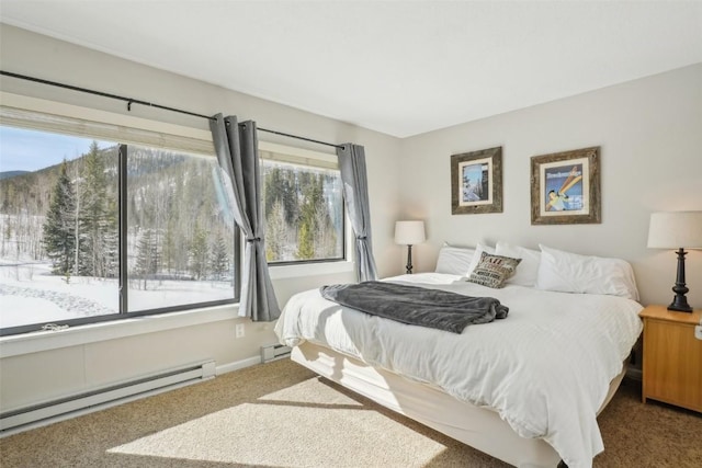 bedroom with carpet, baseboards, and baseboard heating