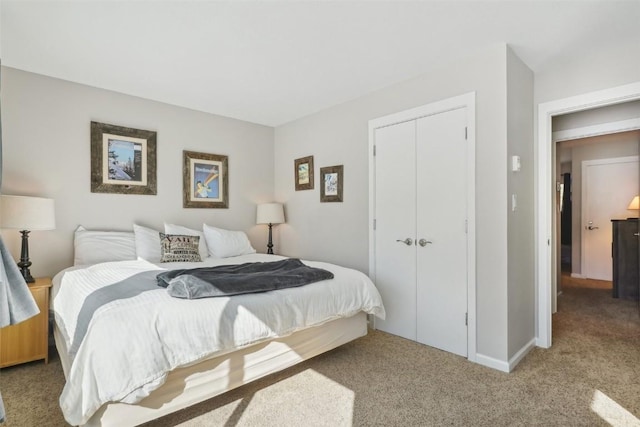 bedroom featuring a closet, carpet floors, and baseboards