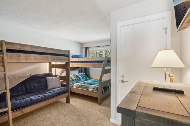 carpeted bedroom featuring a textured ceiling