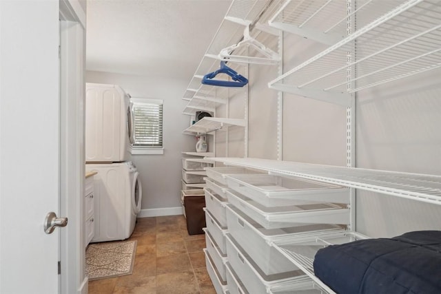 walk in closet featuring stacked washer / dryer