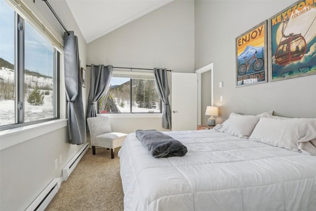 bedroom featuring vaulted ceiling, baseboard heating, a baseboard heating unit, and carpet floors