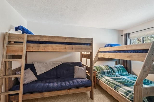 bedroom with a textured ceiling and carpet floors