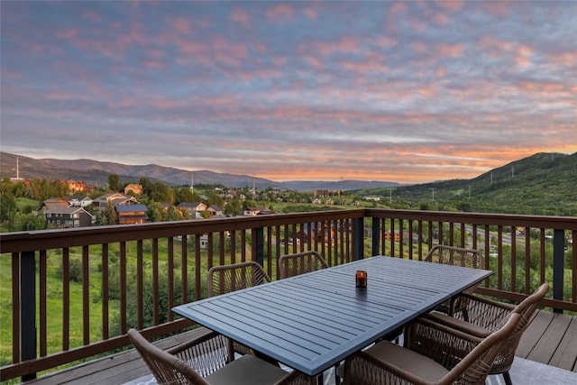 524 Buena Vista Ct, Steamboat Springs, CO 80487 - deck at dusk featuring a mountain view and outdoor dining space