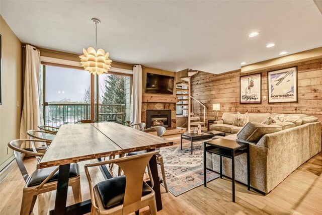 165 Argentine Ct Unit 1407, Keystone, CO 80435 - living area with wood walls, light wood finished floors, a fireplace with raised hearth, and recessed lighting