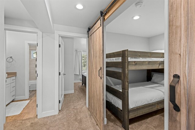 112 Illinois Gulch Rd Unit 6, Breckenridge, CO 80424 - bedroom with recessed lighting, a barn door, light colored carpet, and baseboards