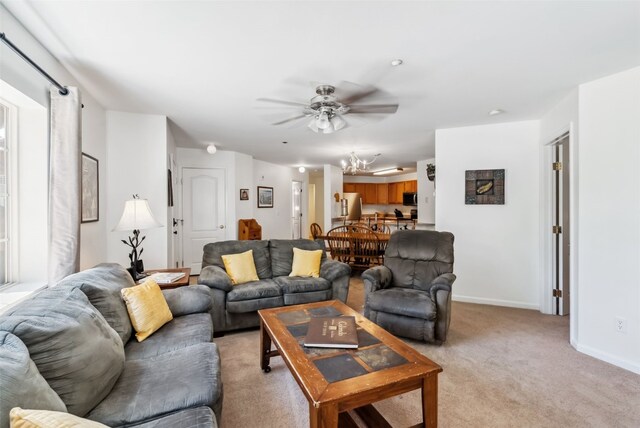 283 Pelican Cir Unit 1703, Breckenridge, CO 80424 - living room featuring light carpet, baseboards, and ceiling fan with notable chandelier