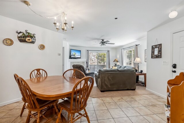 283 Pelican Cir Unit 1703, Breckenridge, CO 80424 - dining area with light tile patterned floors, a tiled fireplace, baseboards, and ceiling fan with notable chandelier