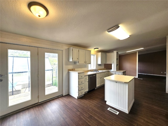 21762 4th Ave, Phippsburg, CO 80469 - kitchen featuring dishwasher, light countertops, dark wood-style floors, a textured ceiling, and a kitchen island