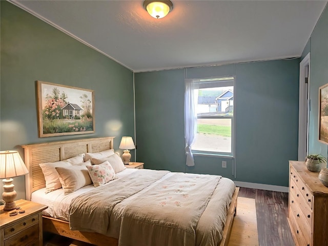 21762 4th Ave, Phippsburg, CO 80469 - bedroom featuring wood finished floors, vaulted ceiling, and ornamental molding