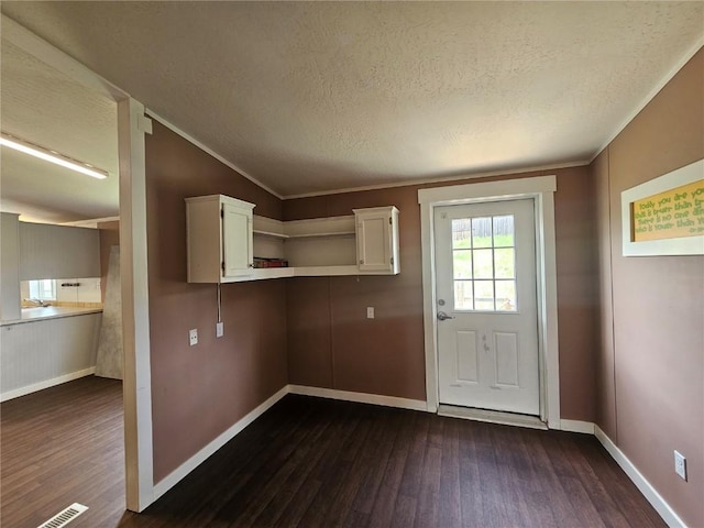 21762 4th Ave, Phippsburg, CO 80469 - doorway to outside featuring dark wood-style flooring, a textured ceiling, baseboards, and ornamental molding