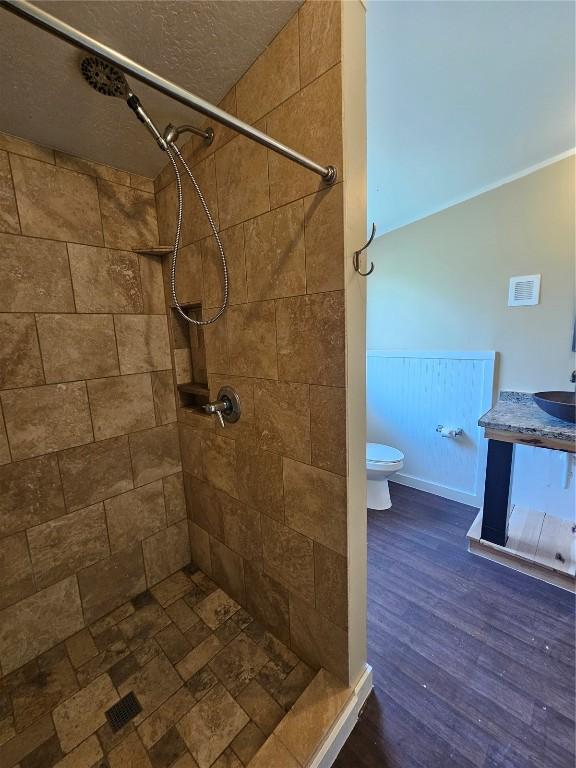 21762 4th Ave, Phippsburg, CO 80469 - full bath featuring tiled shower, vanity, and wood finished floors