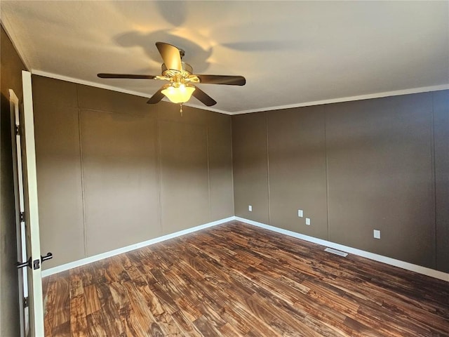 21762 4th Ave, Phippsburg, CO 80469 - empty room featuring dark wood-style flooring, ceiling fan, a decorative wall, and crown molding