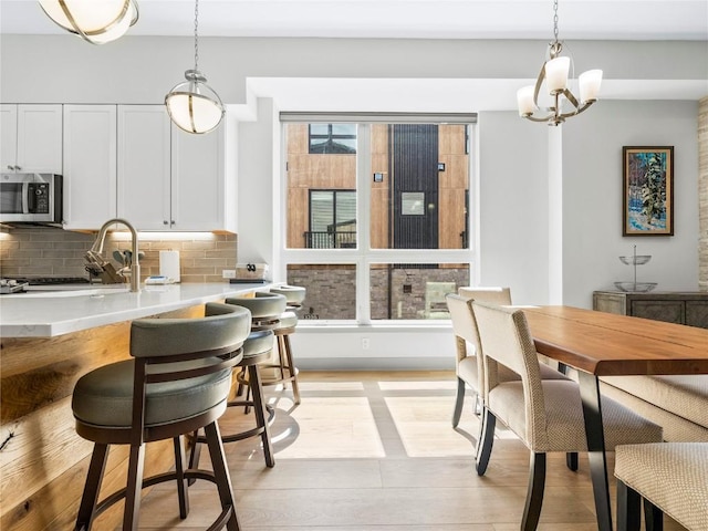 62 W 3rd St Unit D, Silverthorne, CO 80498 - dining area featuring a chandelier and light wood-type flooring