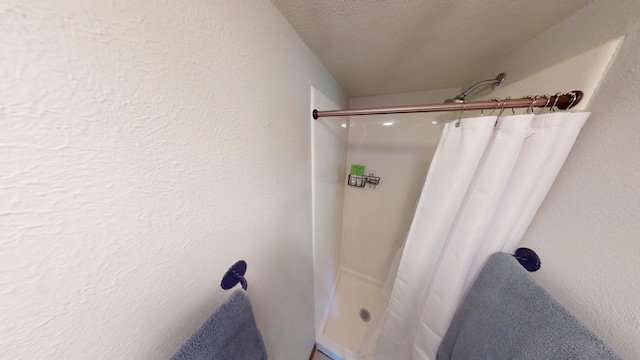 9876 Ryan Gulch Rd Unit 106, Silverthorne, CO 80498 - bathroom featuring a shower with shower curtain and a textured ceiling