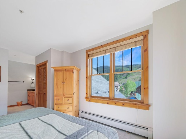 100 Dercum Sq Unit 8389, Keystone, CO 80435 - bedroom featuring a baseboard heating unit, light carpet, a closet, and ensuite bath