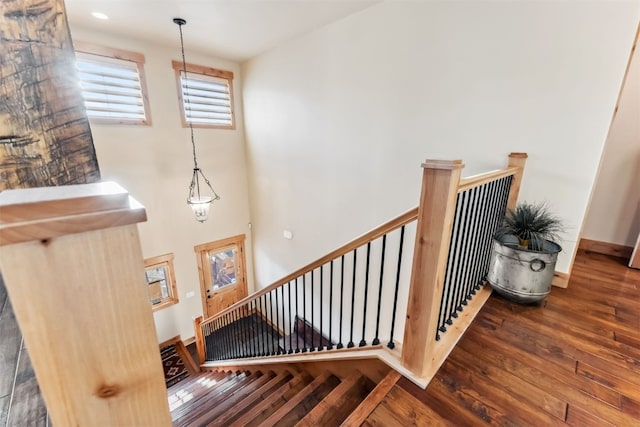 stairs with hardwood / wood-style flooring and baseboards