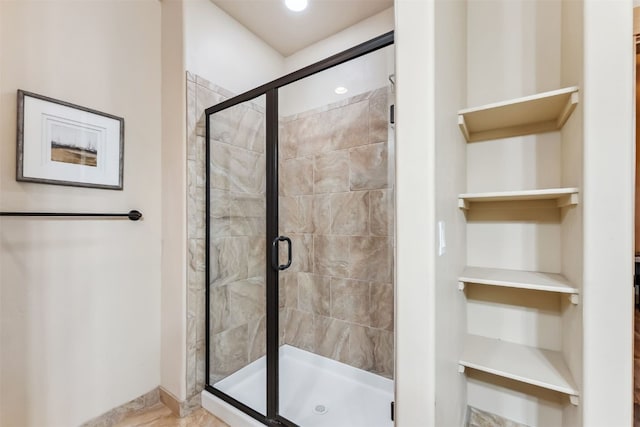 full bath with baseboards and a stall shower