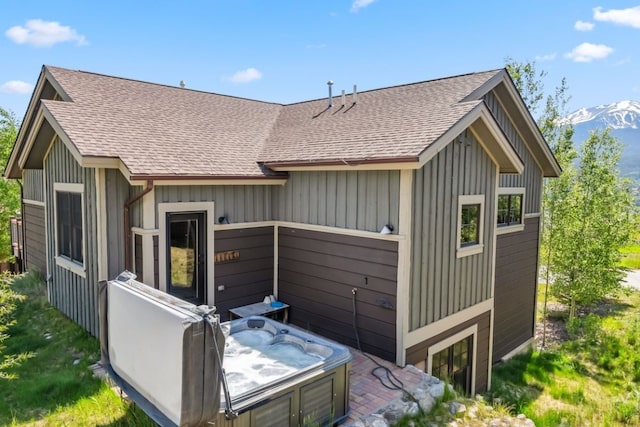 52 Buckskin Ln, Silverthorne, CO 80498 - back of property with a hot tub, roof with shingles, and a mountain view