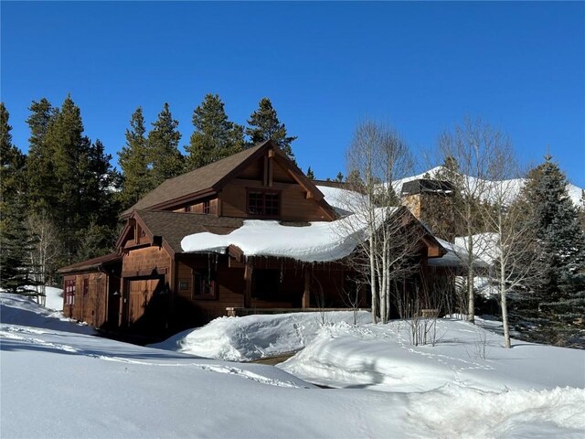 168 Corkscrew Dr, Breckenridge, CO 80424 - view of snowy exterior with a chimney