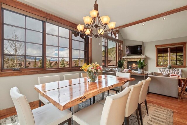 168 Corkscrew Dr, Breckenridge, CO 80424 - dining room featuring a chandelier, a lit fireplace, wood finished floors, plenty of natural light, and recessed lighting