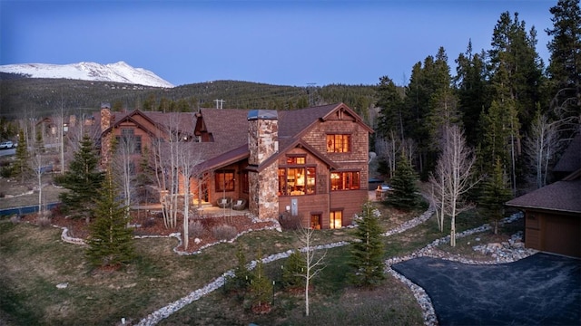 168 Corkscrew Dr, Breckenridge, CO 80424 - rear view of property featuring a chimney, a mountain view, and stone siding