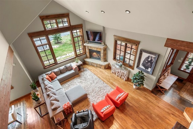 168 Corkscrew Dr, Breckenridge, CO 80424 - living room featuring a fireplace, high vaulted ceiling, wood finished floors, and recessed lighting