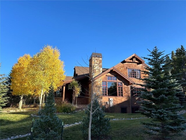 168 Corkscrew Dr, Breckenridge, CO 80424 - view of side of home with a lawn and a chimney